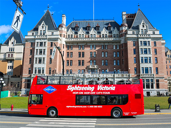 a picture of the Empress in downtown Victoria with a 'Sightseeing Victoria' bus passing in front.