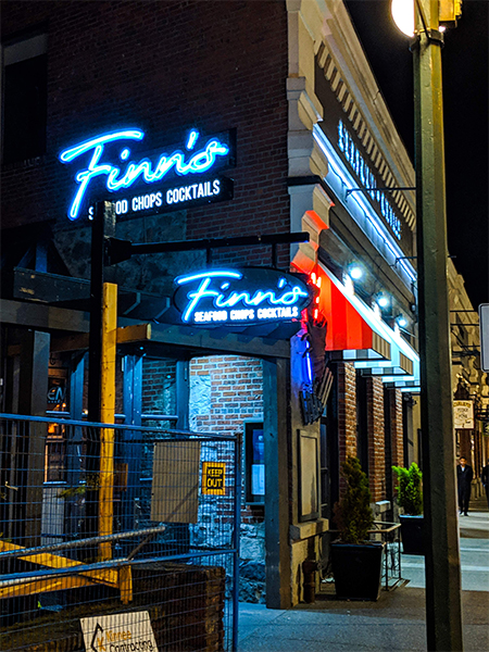 a shot of Finn's restaurant in downtown Victoria at night.