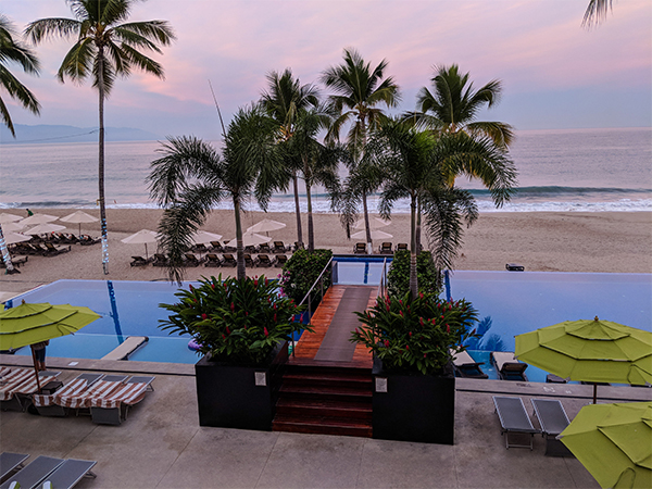 a picture of a resort pool and hottub in Mexico that face the beach.